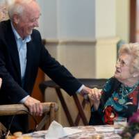 Doug and Barbara Kindschi greeting Mrs. Barbara Gordon at her table